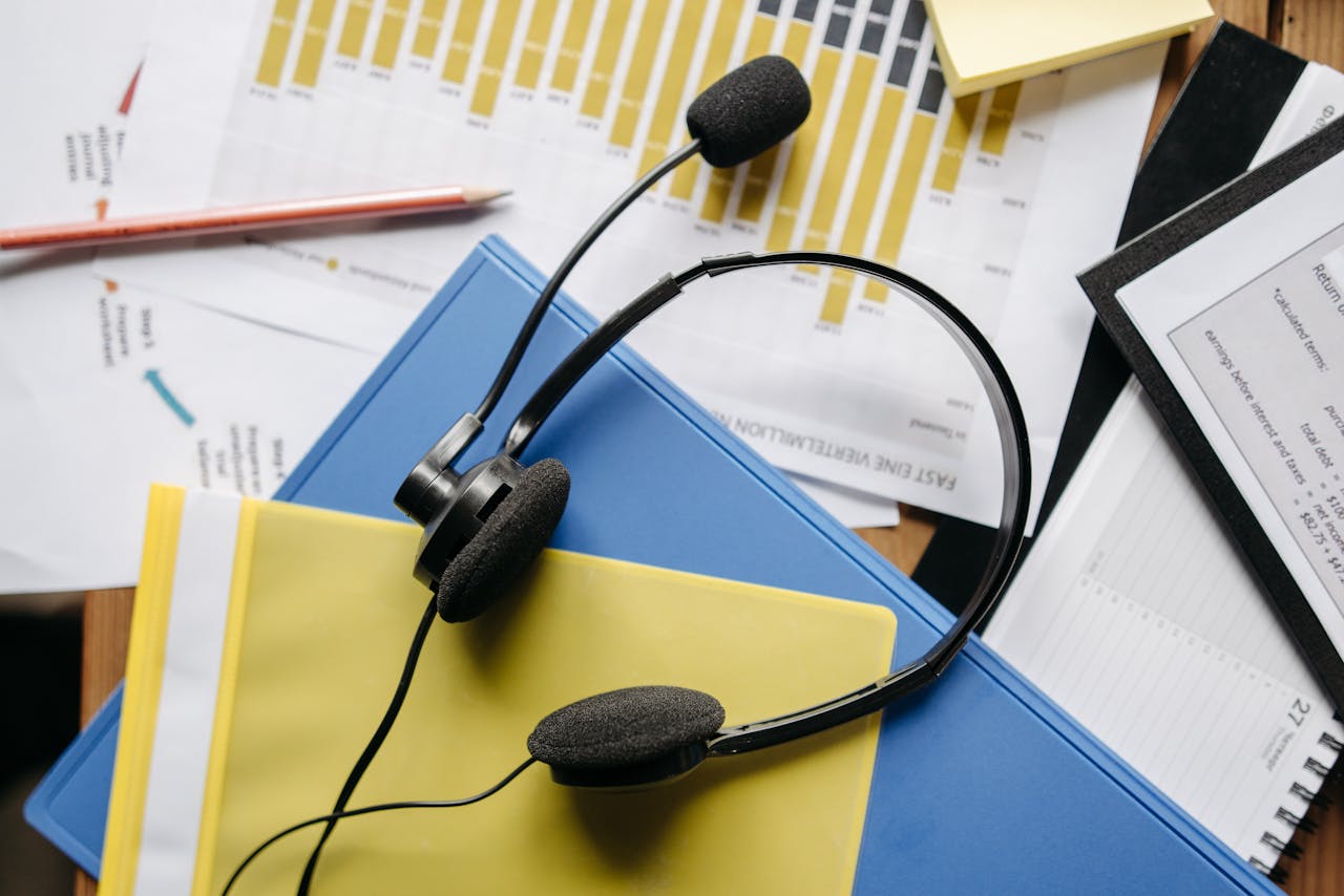 Services Close-up of an office desk with headset, charts, and documents showcasing customer service support.